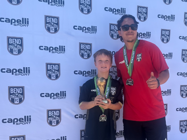 Bend FC player and coach with trophy